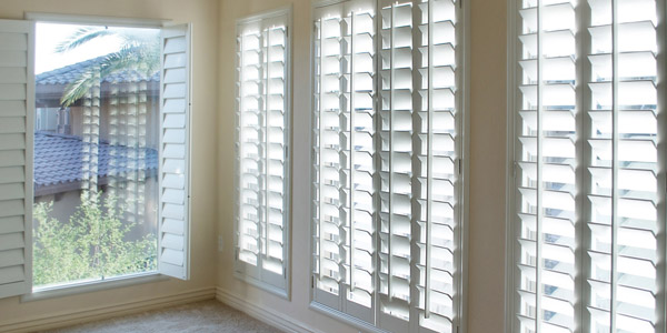 White wood shutters on windows. Accent Verticals provides wood window coverings in Portland OR & Vancouver WA.