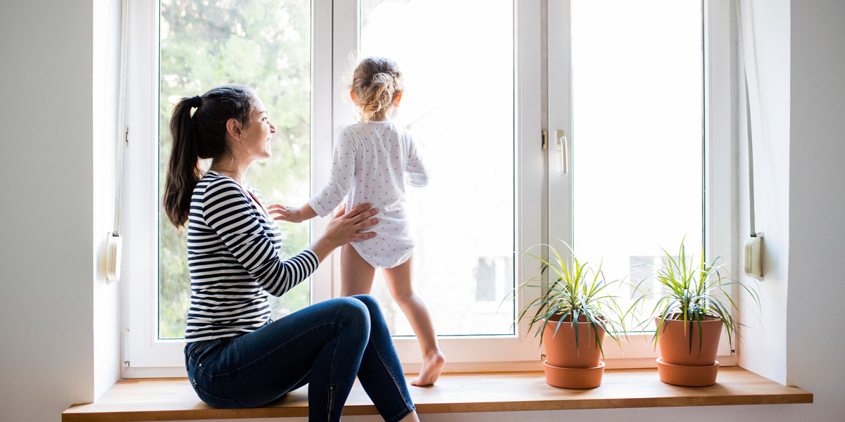 Woman and child near window. Accent Verticals, serving Portland OR & Vancouver WA talks about how to childproof your window coverings.