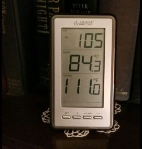 Thermometer showing temperature lowering from blackout curtains